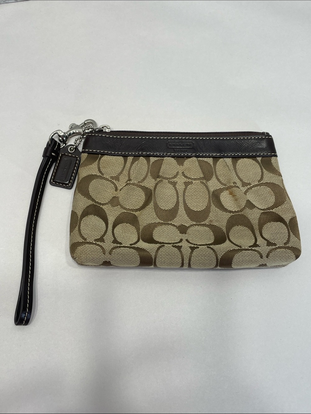 Coach Signature Canvas Wristlet in Khaki/Brown. Preowned. Has exterior spots.